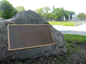 A memorial stone to Naval Corpsman Joseph F. Keenan sits in a corner of his boyhood playground, Wainwright/Cronin  Park. Just outside the park to the right of the photograph, yards from his home, is Marine Pfc. Allen H. MacQuarrie Square.	          Photo by Pat Tarantino